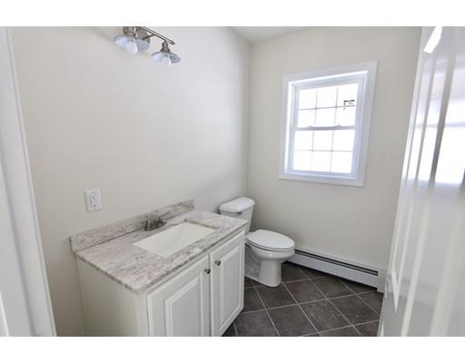 57 Leominster Road Shirley, MA 01464 - Photo 12 of 13 a bathroom with a granite countertop sink a toilet and a window
