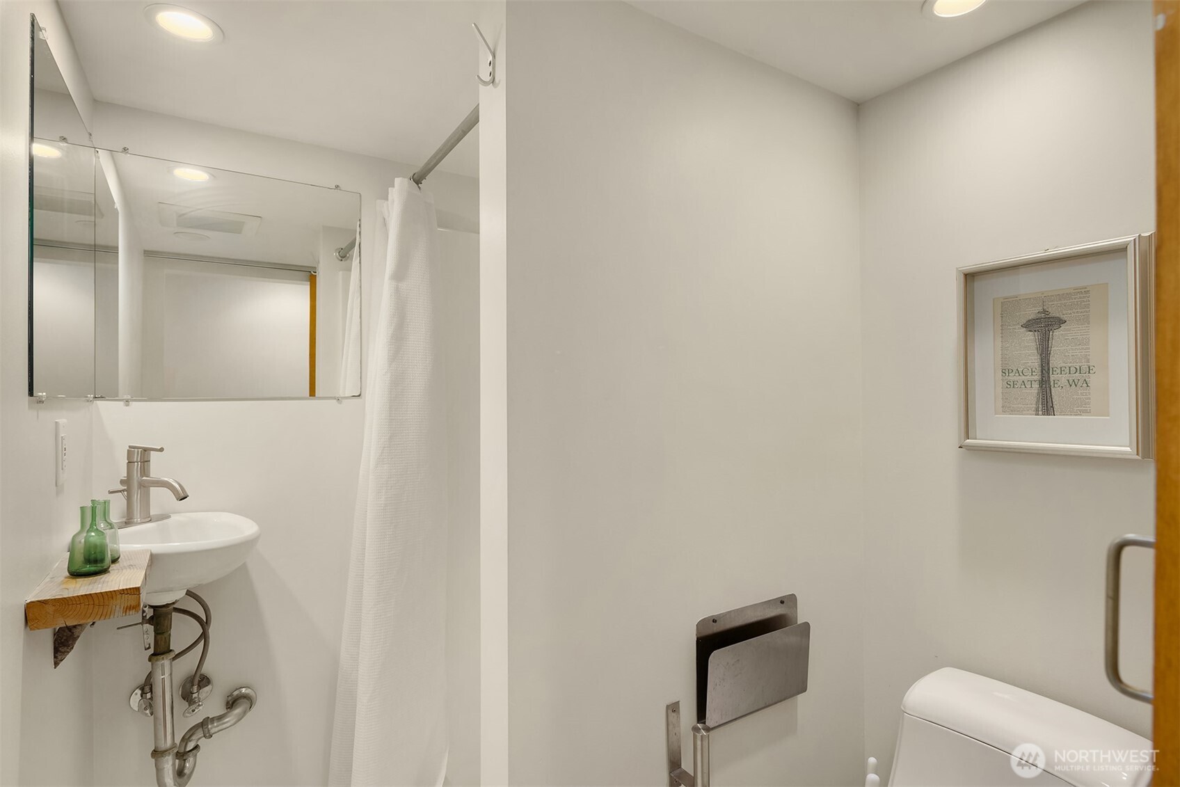 112 18th Avenue Seattle, WA 98122 - Photo 12 of 30 a bathroom with a toilet a sink and mirror