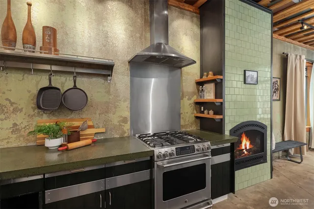 a kitchen with a stove and a wooden floor