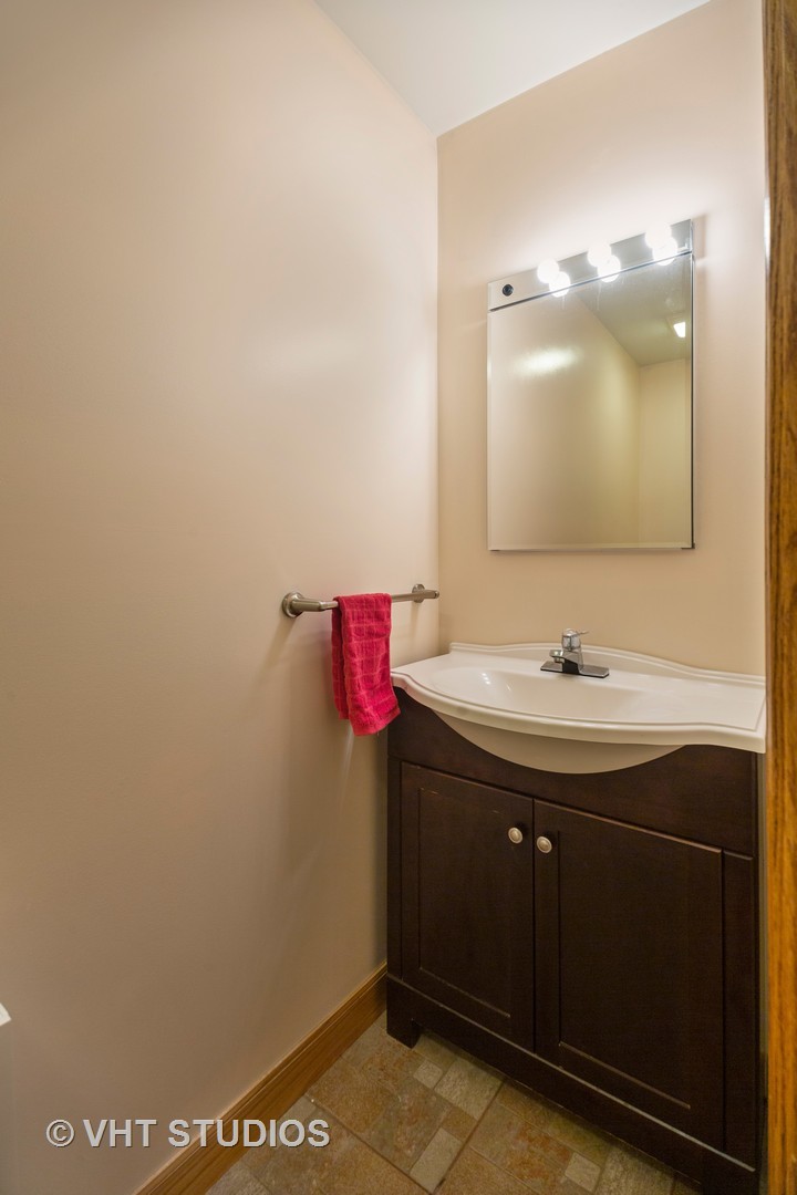 3105 Patton Drive Des Plaines, IL 60018 - Photo 21 of 27 a bathroom with a sink and a mirror