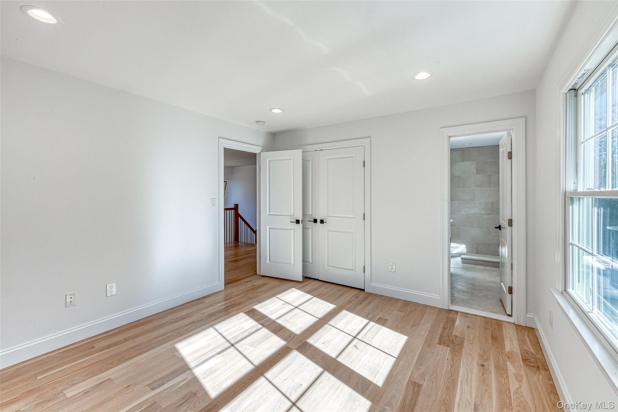 141 Old Cedar Swamp Road Jericho, NY 11753 - Photo 15 of 15 a view of empty room with wooden floor and fan