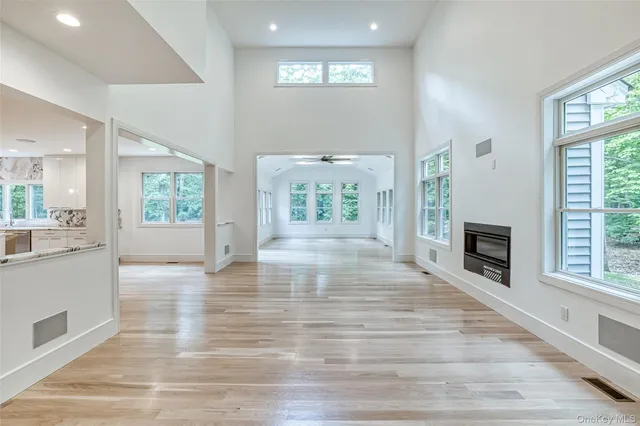 an empty room with wooden floor and a fireplace