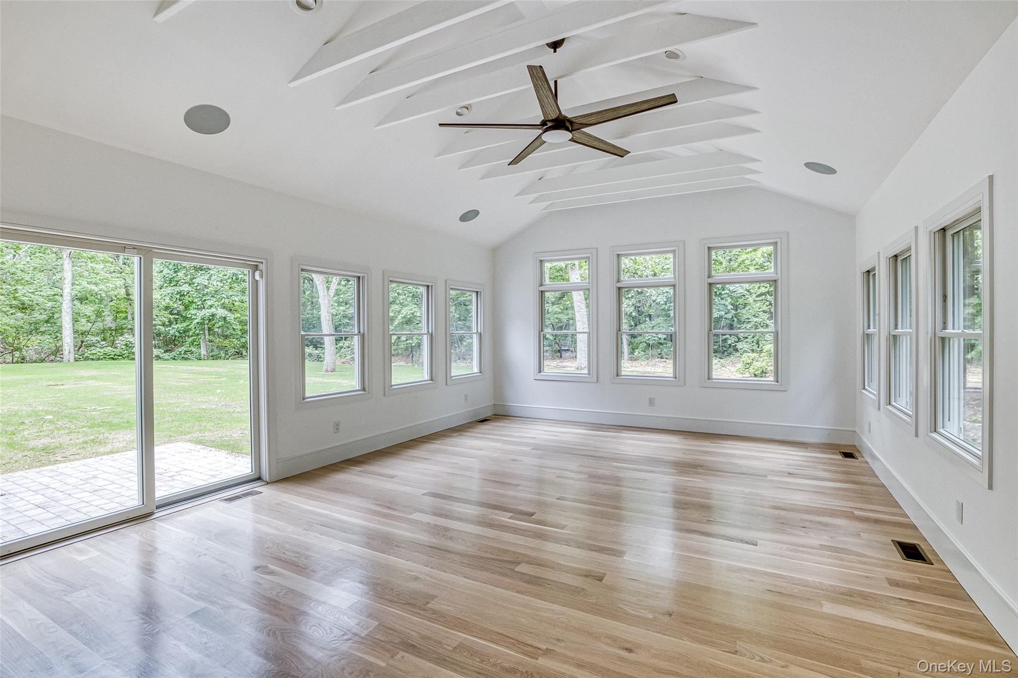 141 Old Cedar Swamp Road Jericho, NY 11753 - Photo 7 of 15 a view of an empty room with wooden floor and a window