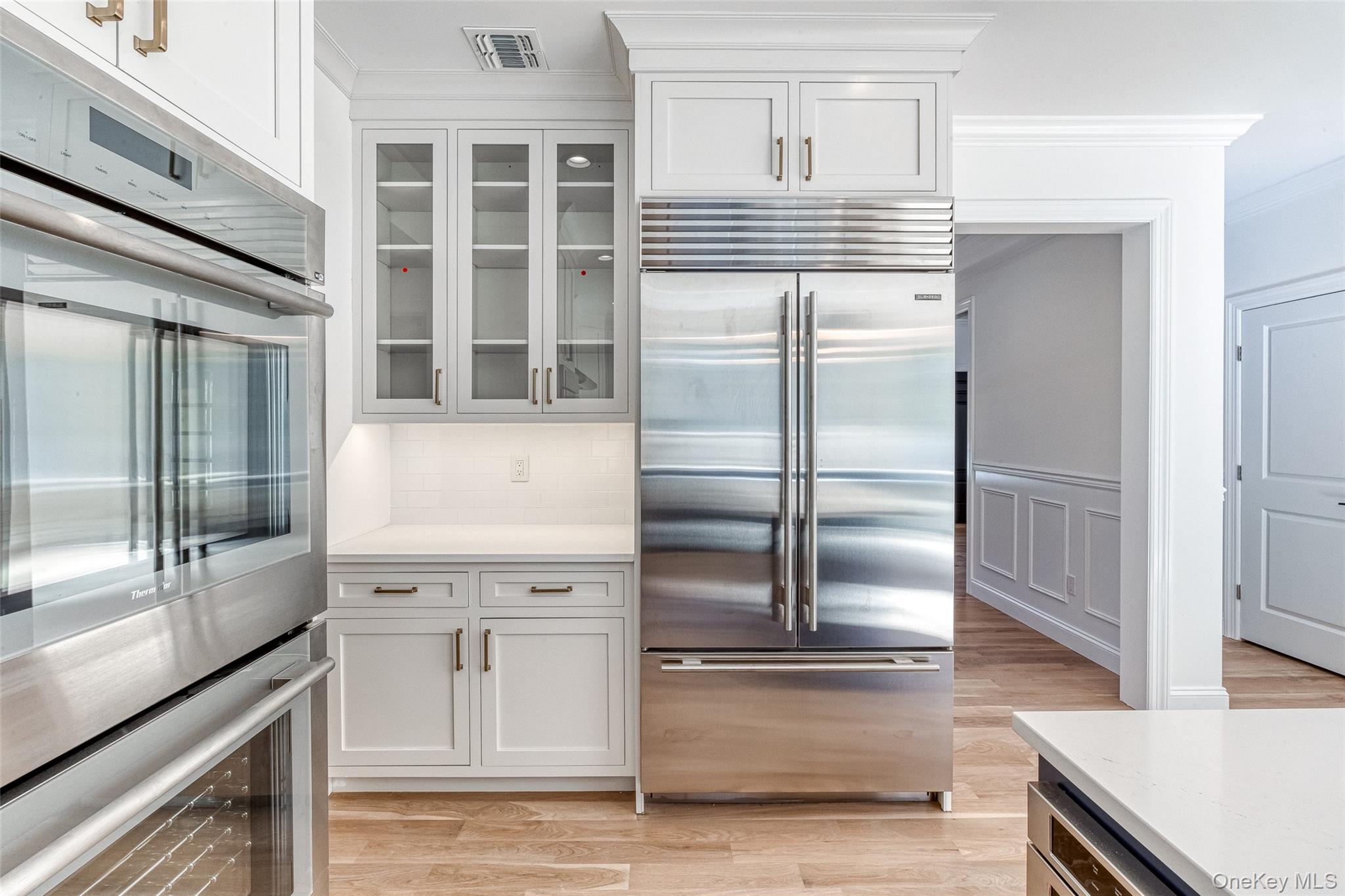 141 Old Cedar Swamp Road Jericho, NY 11753 - Photo 8 of 15 a kitchen with stainless steel appliances cabinets and a counter top