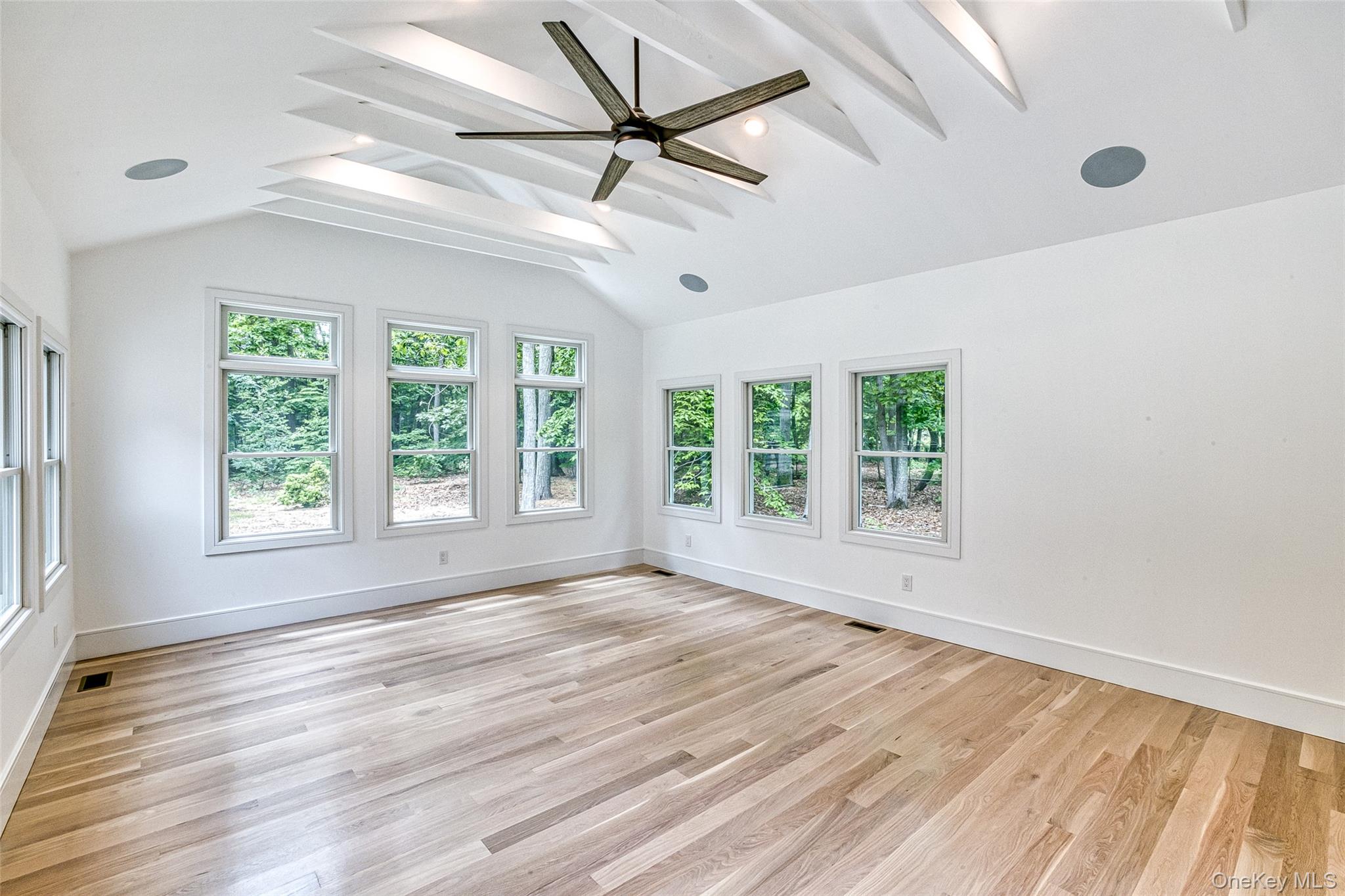 141 Old Cedar Swamp Road Jericho, NY 11753 - Photo 9 of 15 a view of an empty room with a window and wooden floor