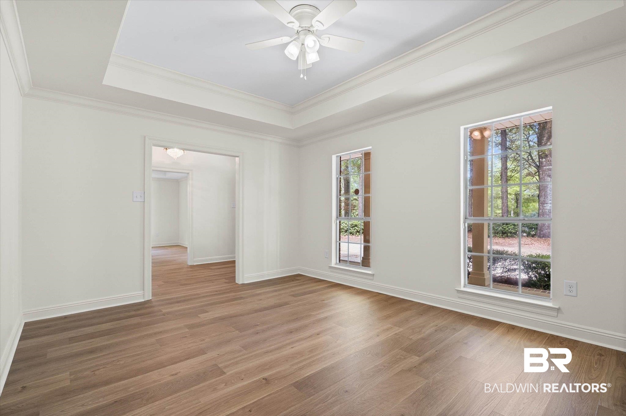 3451 Lacoste Road Mobile, AL 36618 - Photo 3 of 36 Unfurnished room featuring ceiling fan, wood finished floors, a tray ceiling, and crown molding