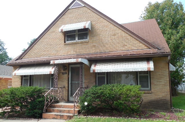 1517 Quentin Road Rockford, IL 61108 - Photo 1 of 1 a front view of a house with garage
