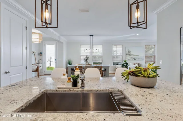 a kitchen with a sink and breakfast area