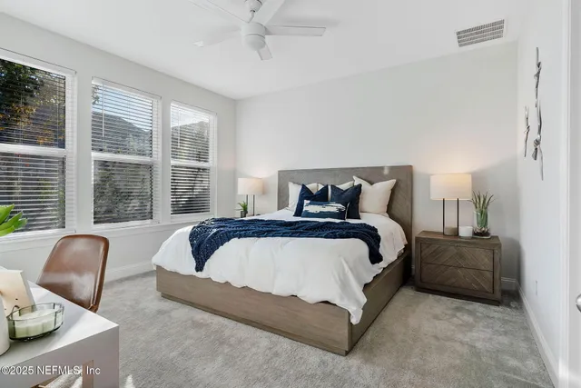 a bedroom with bed and glass window