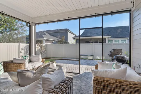 a backyard of a house with barbeque oven table and chairs