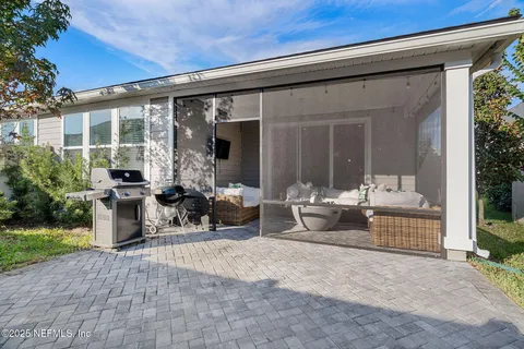 a view of a white house with a big yard and large tree