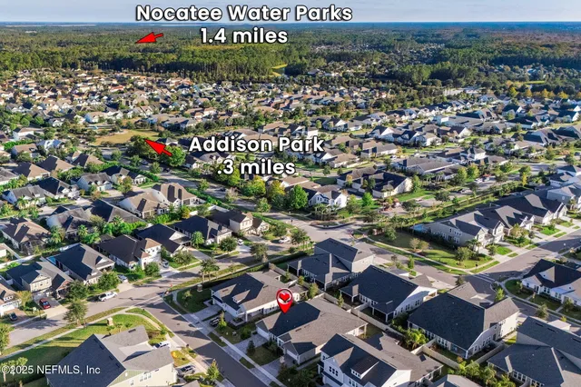 a view of a patio with a table and chairs under an umbrella with large trees