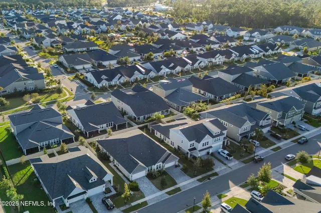 a view of a patio with a table and chairs under an umbrella