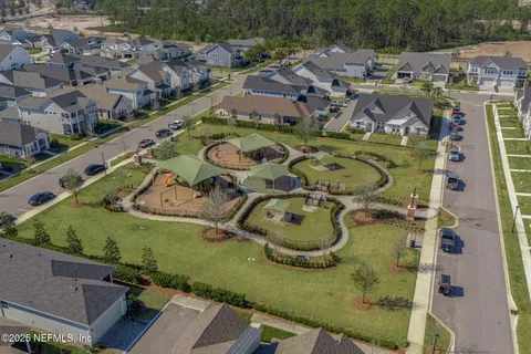 an aerial view of a house with a garden and lake view