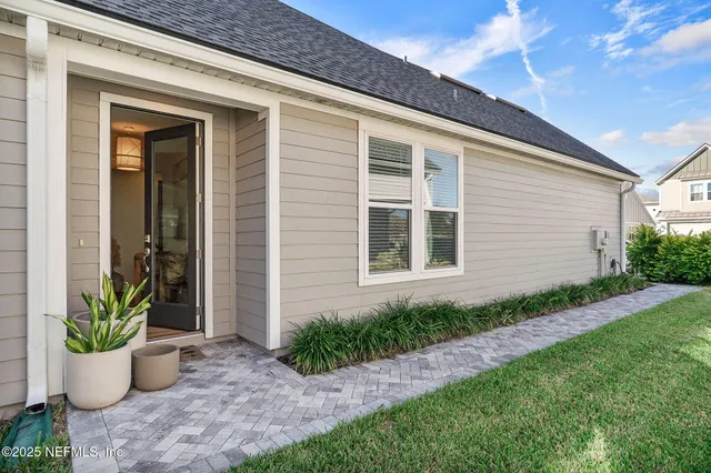 a view of a house with potted plants and a potted plant