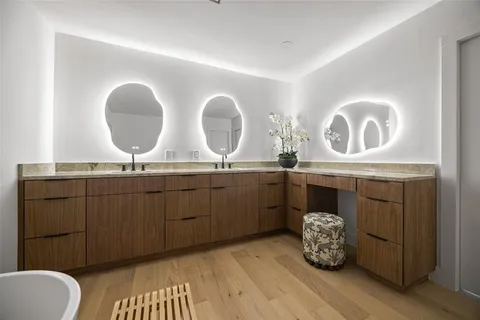 a bathroom with a double vanity sink and a mirror