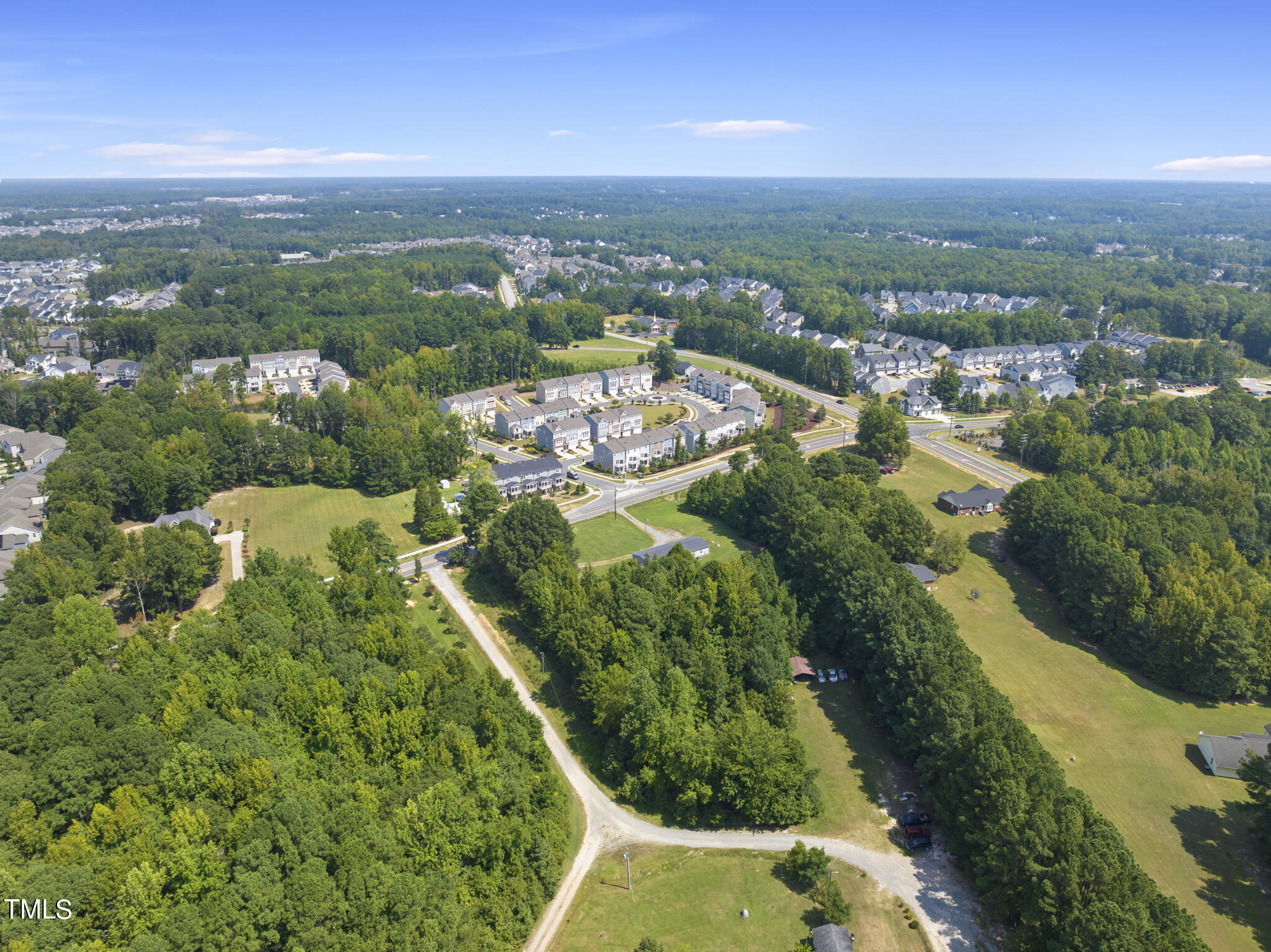 8129 Humie Olive Road Apex, NC 27502 - Photo 13 of 25 an aerial view of residential houses with outdoor space and trees