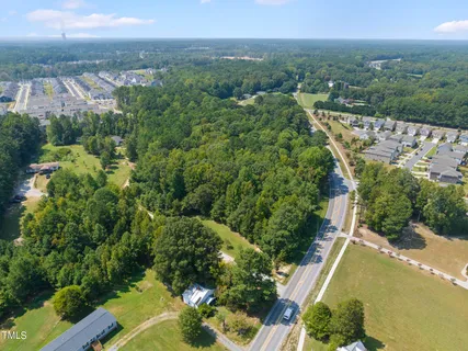 an aerial view of a house with a yard and lake view