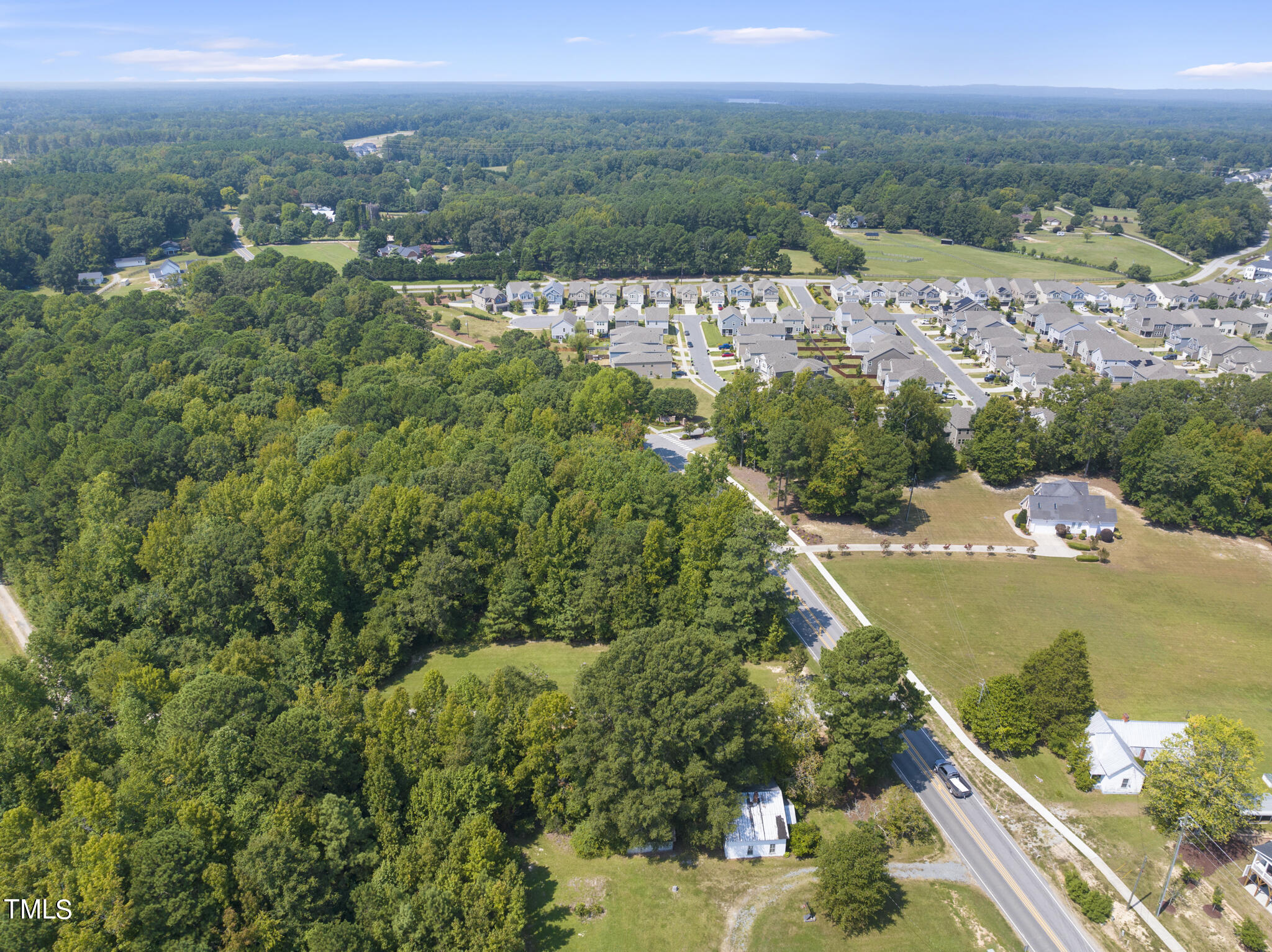 8129 Humie Olive Road Apex, NC 27502 - Photo 17 of 25 an aerial view of a house with a yard and lake view