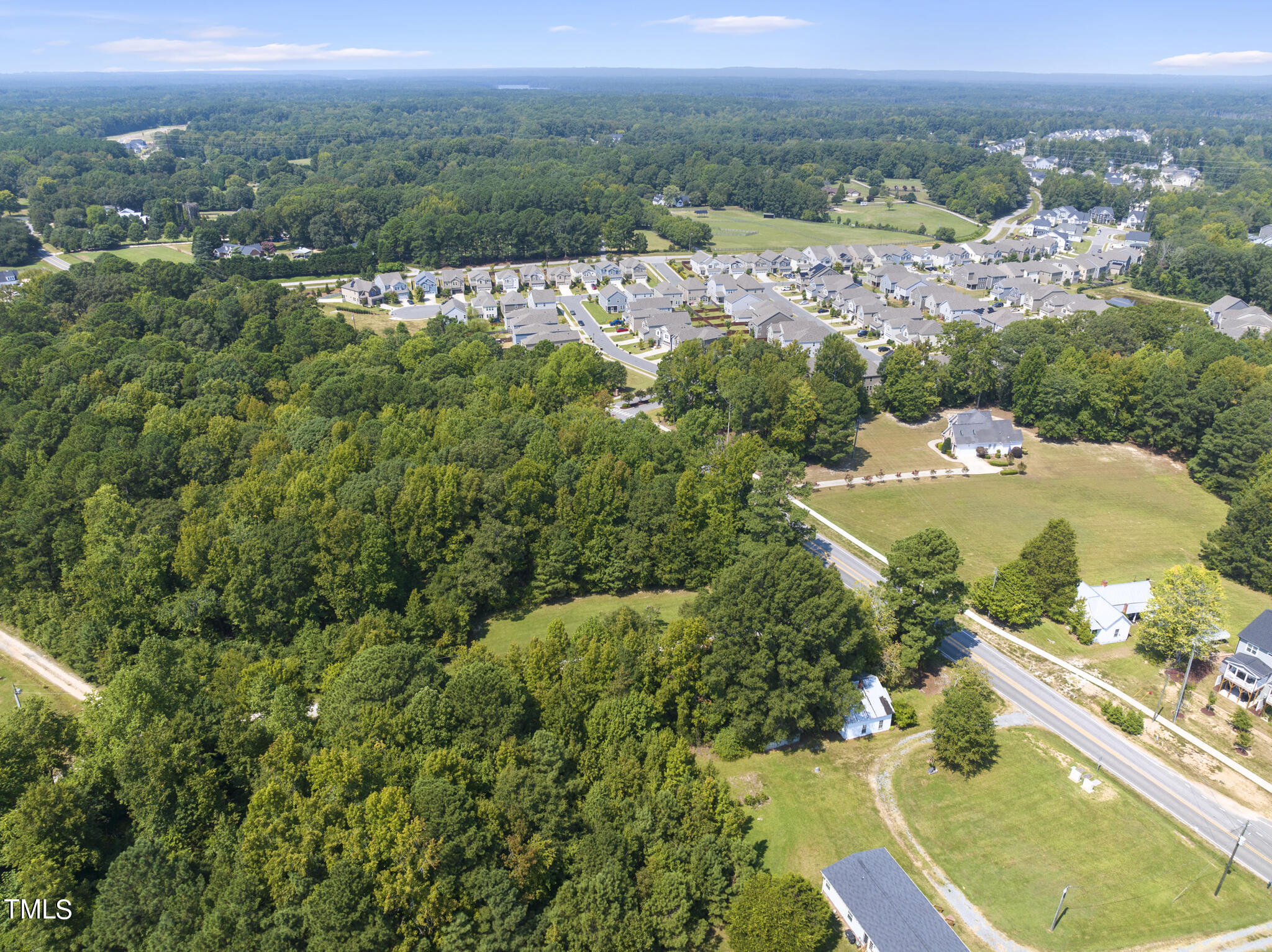 8129 Humie Olive Road Apex, NC 27502 - Photo 18 of 25 an aerial view of residential houses with outdoor space and trees