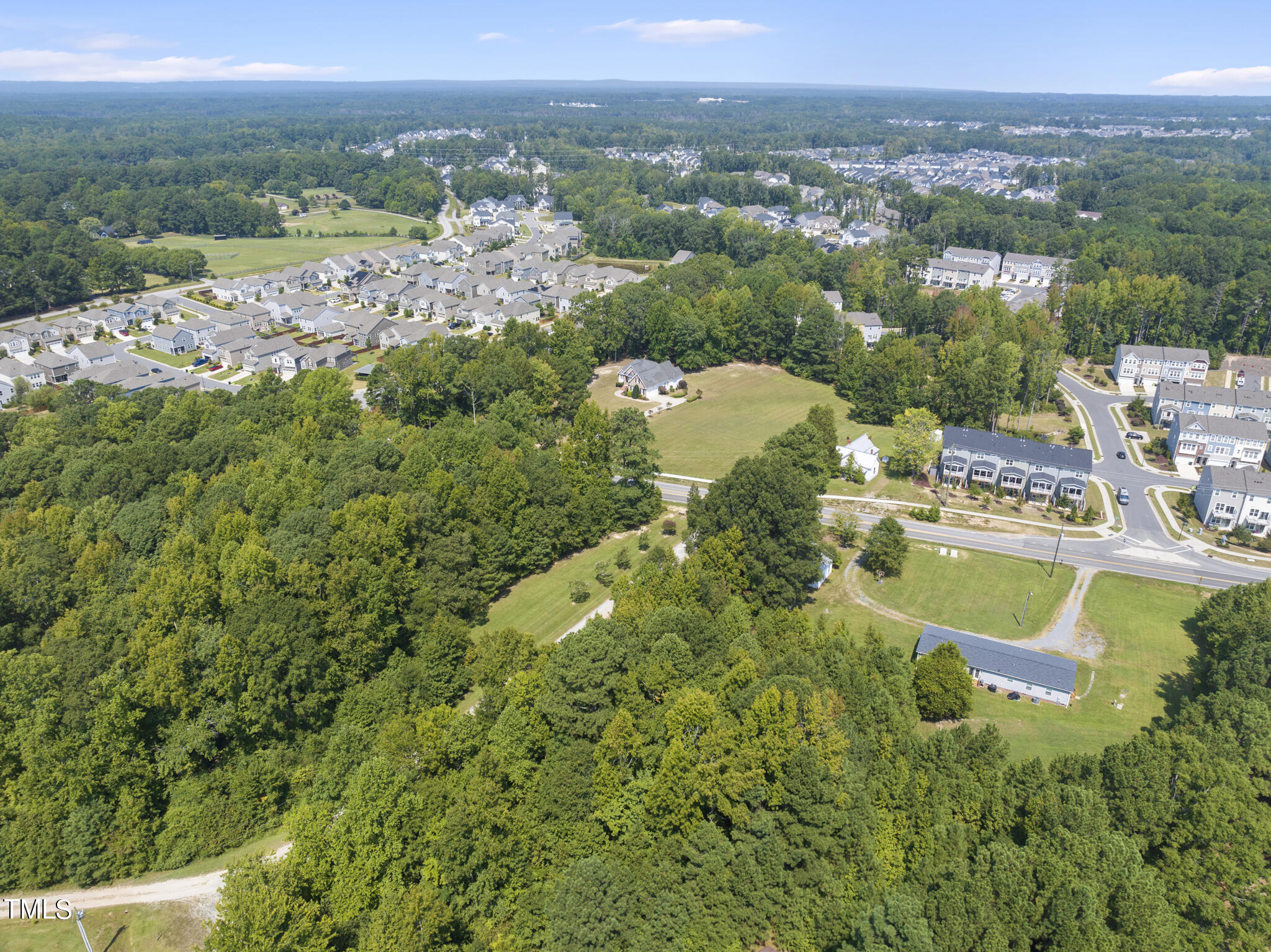8129 Humie Olive Road Apex, NC 27502 - Photo 19 of 25 an aerial view of residential houses with outdoor space and trees