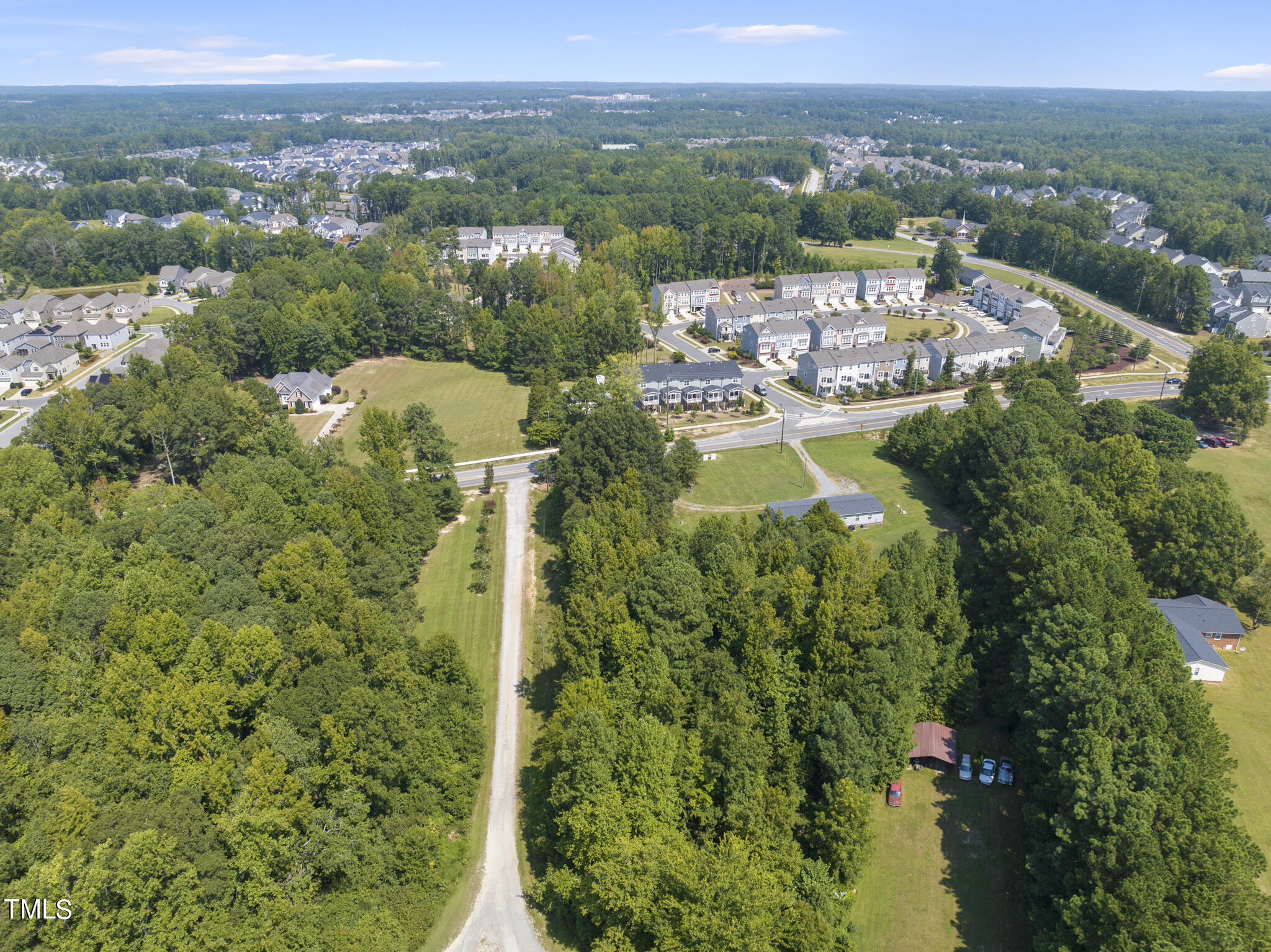 8129 Humie Olive Road Apex, NC 27502 - Photo 20 of 25 a view of a city with lush green forest