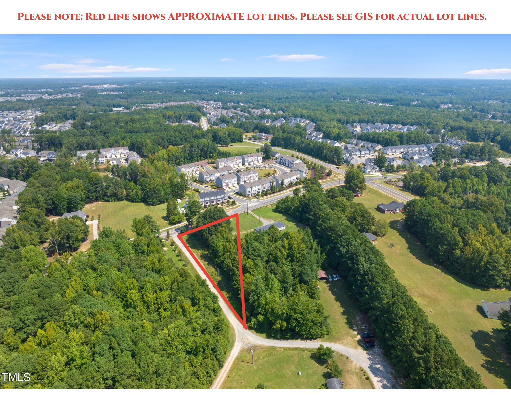 8129 Humie Olive Road Apex, NC 27502 - Photo 2 of 25 an aerial view of residential houses with outdoor space and trees