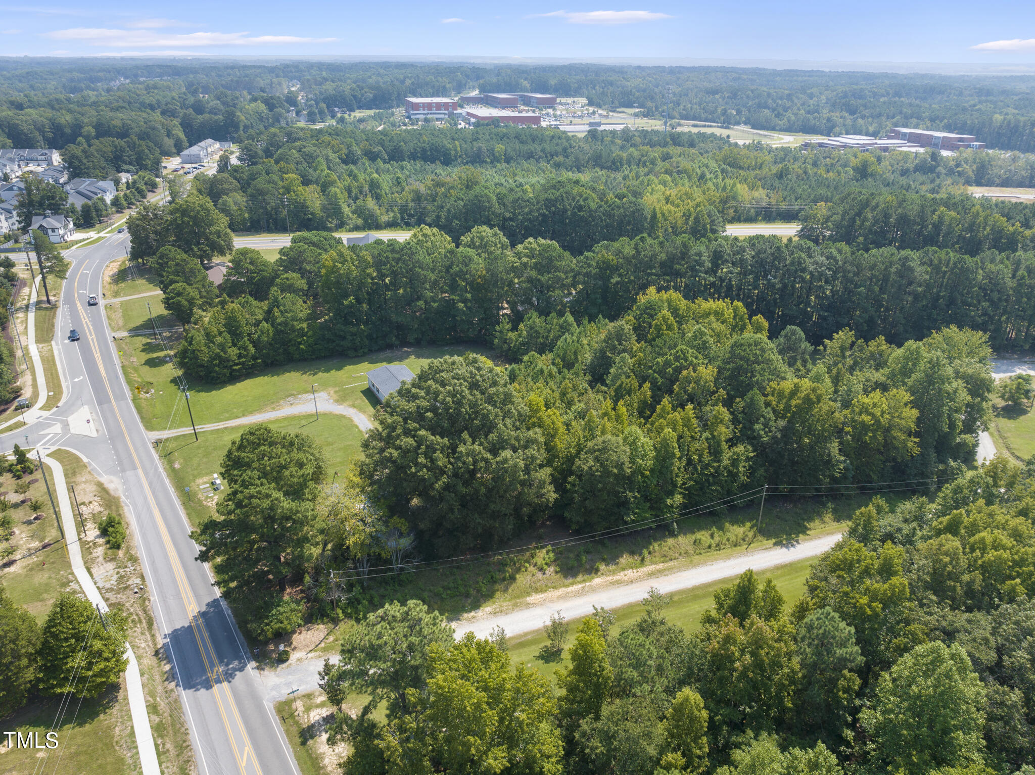 8129 Humie Olive Road Apex, NC 27502 - Photo 23 of 25 an aerial view of residential house with outdoor space and trees all around