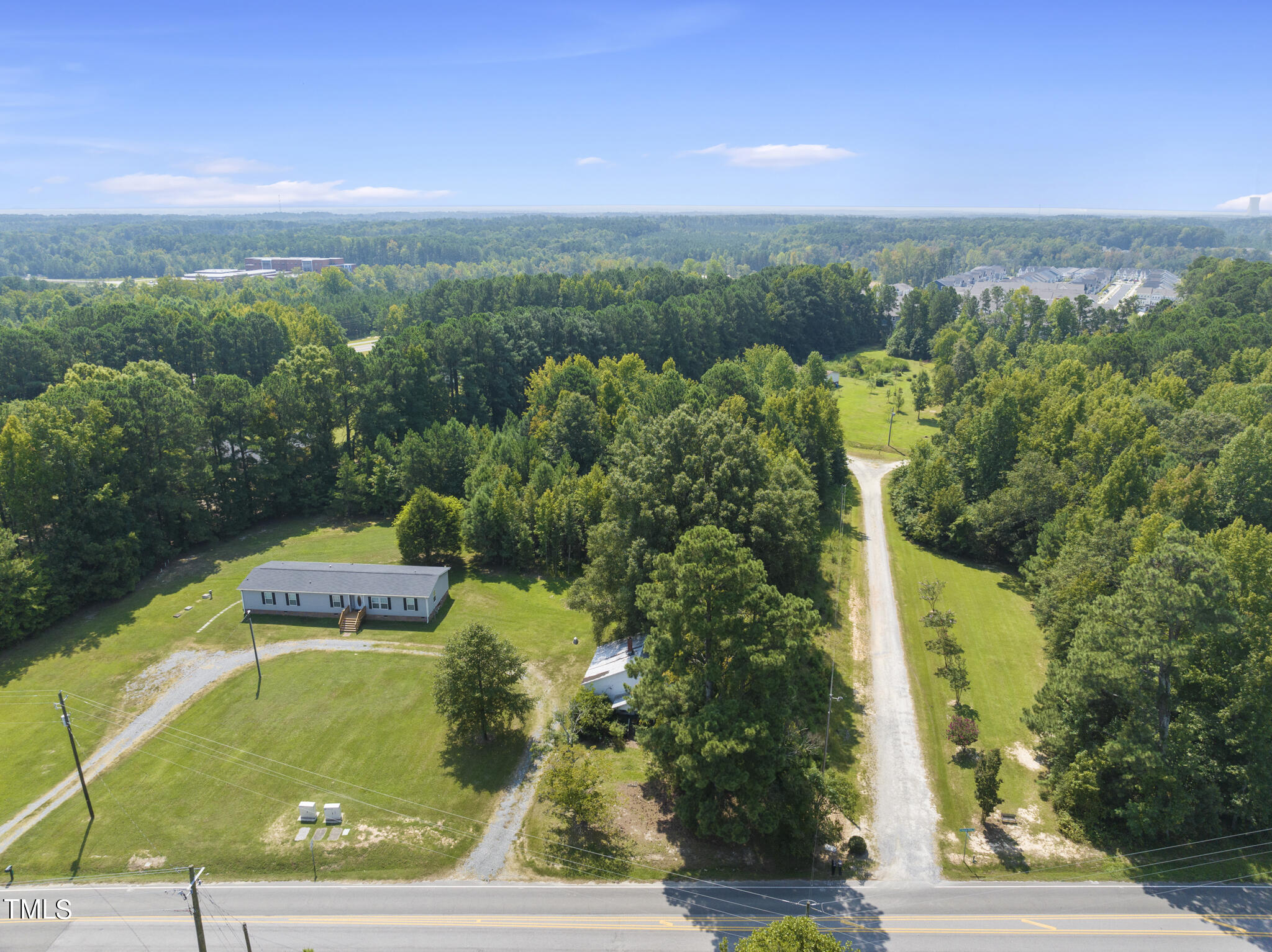 8129 Humie Olive Road Apex, NC 27502 - Photo 25 of 25 a view of a swimming pool with a yard