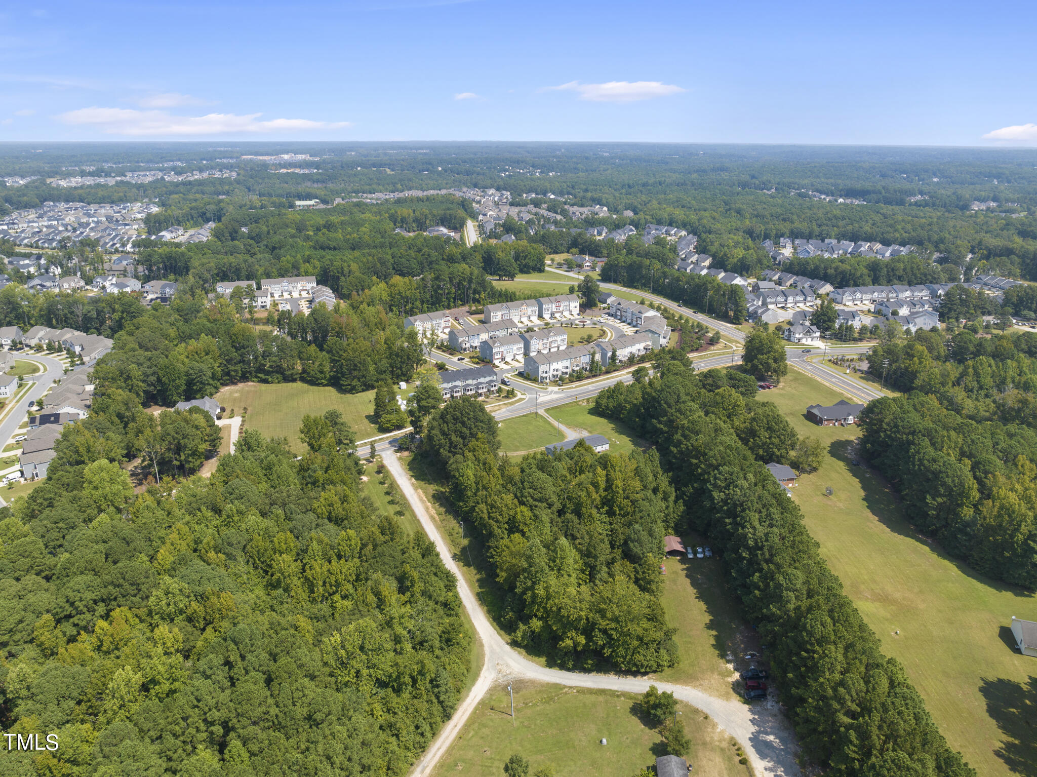 8129 Humie Olive Road Apex, NC 27502 - Photo 4 of 25 an aerial view of residential houses with outdoor space and trees