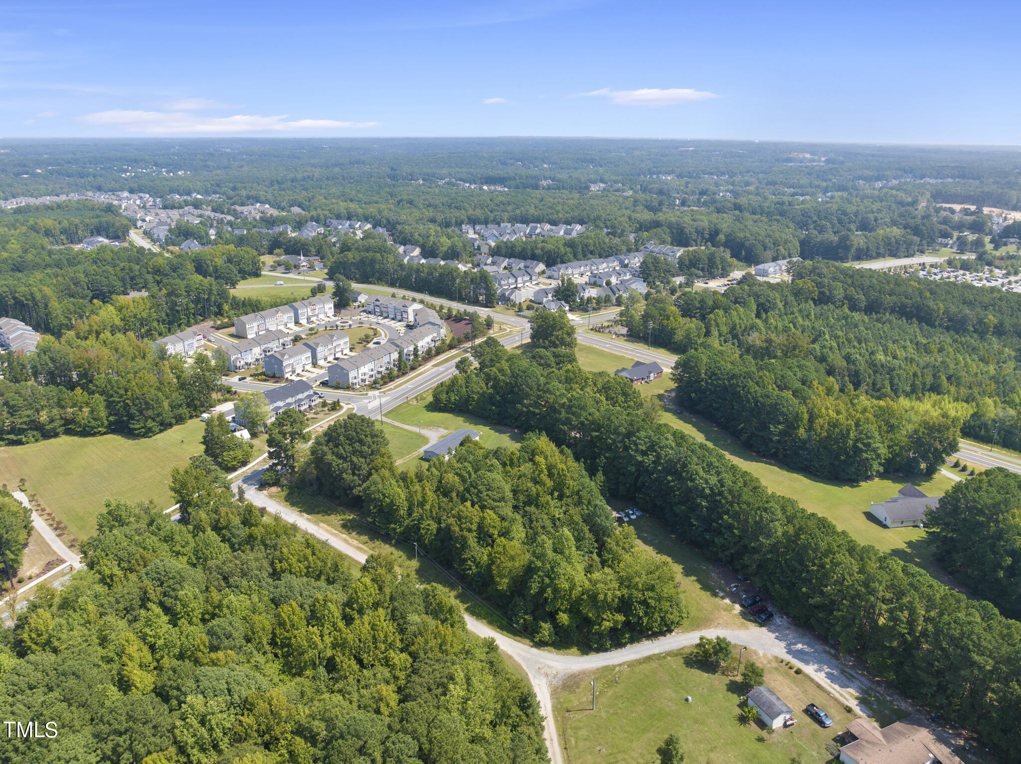 8129 Humie Olive Road Apex, NC 27502 - Photo 5 of 25 an aerial view of residential houses with outdoor space and trees