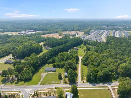 an aerial view of a house with a garden and lake view