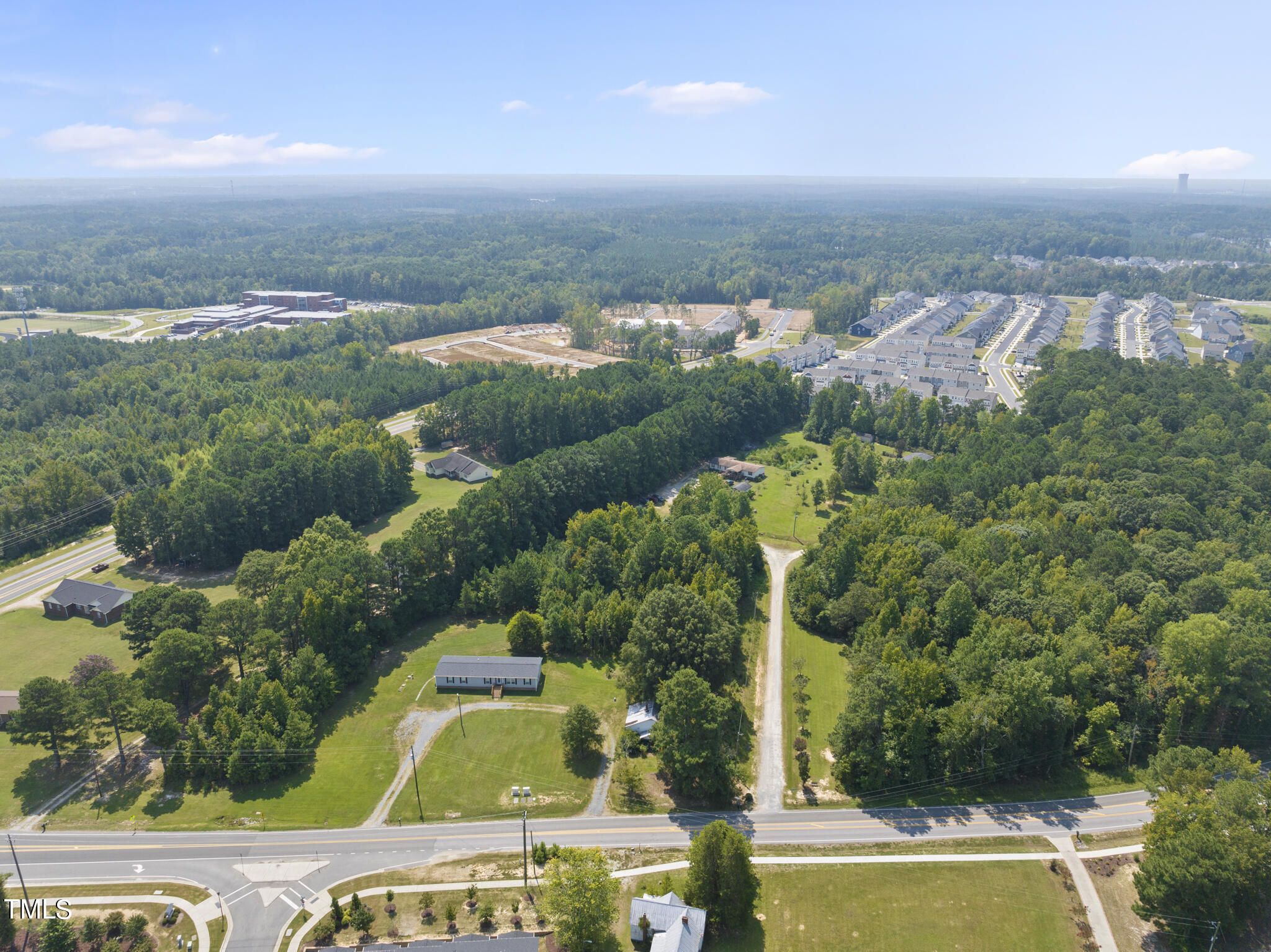 8129 Humie Olive Road Apex, NC 27502 - Photo 8 of 25 an aerial view of a house with a garden and lake view