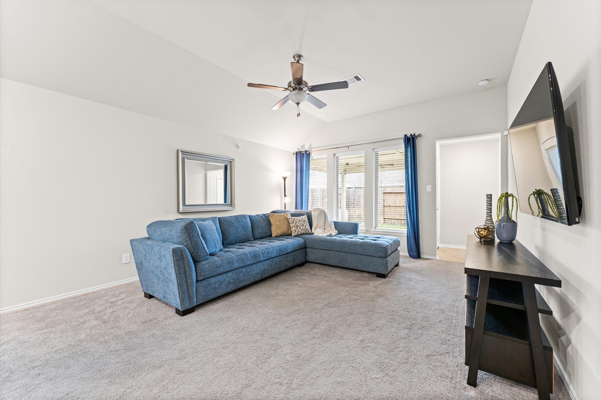 2702 Meadow View Lane Conroe, TX 77385 - Photo 15 of 26 a living room with furniture and a flat screen tv