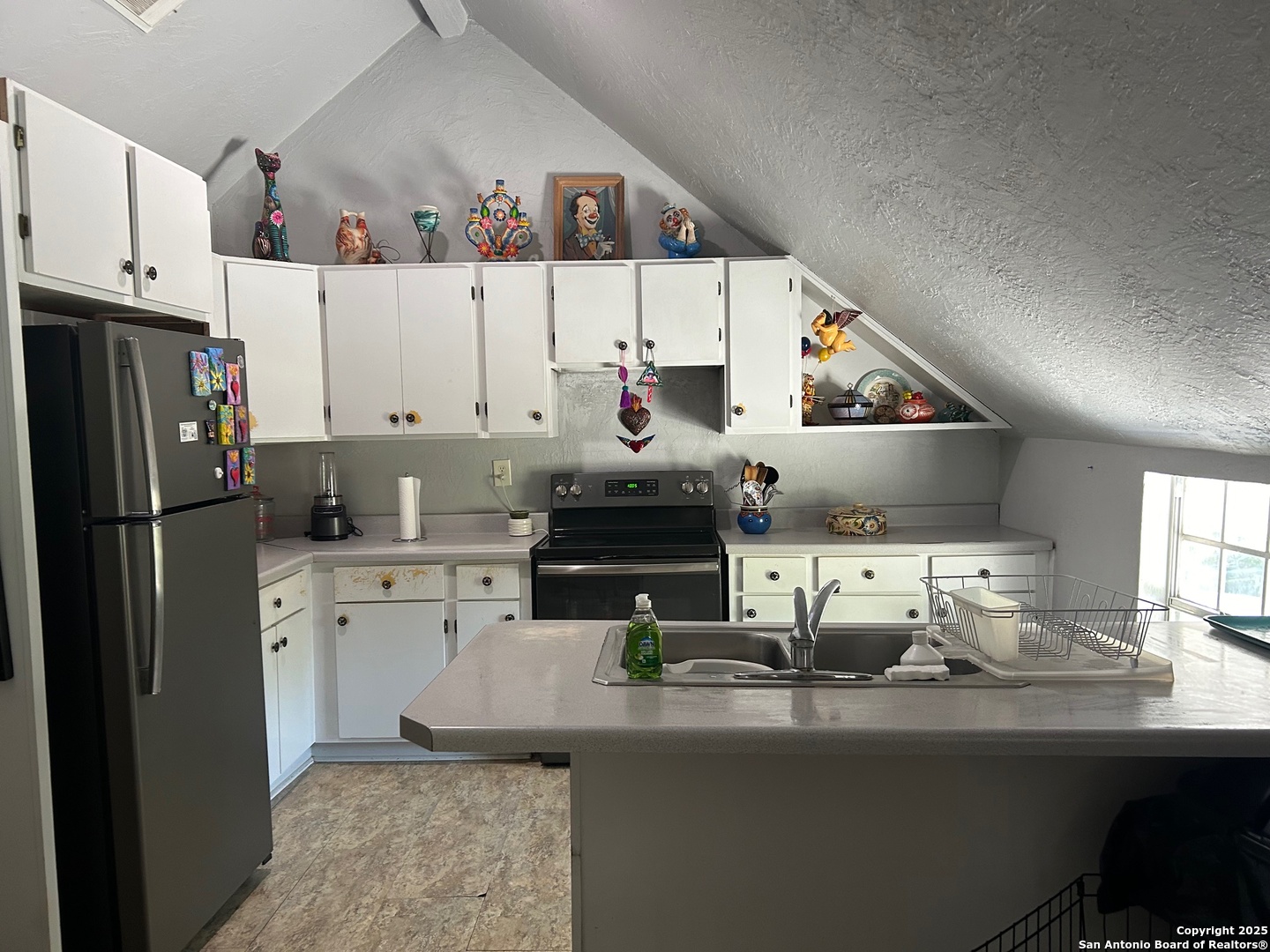 6 Collins Hill Road Lytle, TX 78052 - Photo 6 of 10 a kitchen with counter top space cabinets and stainless steel appliances