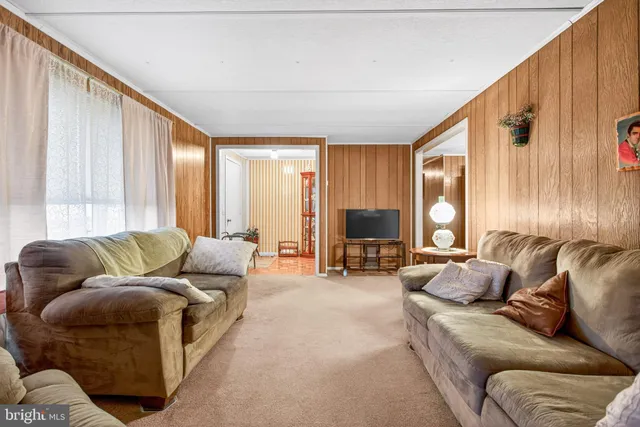 a living room with furniture and large window