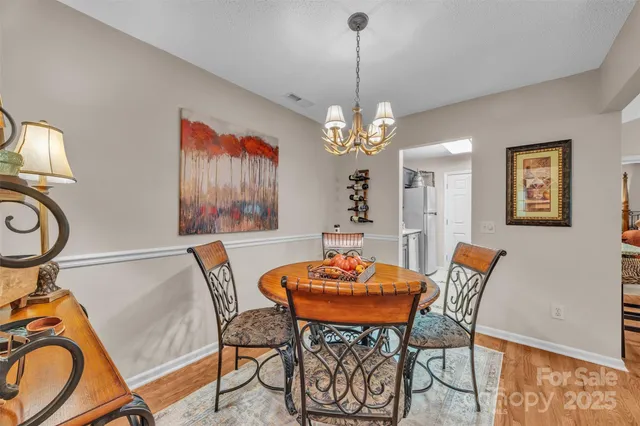 a view of a dining room with furniture and chandelier