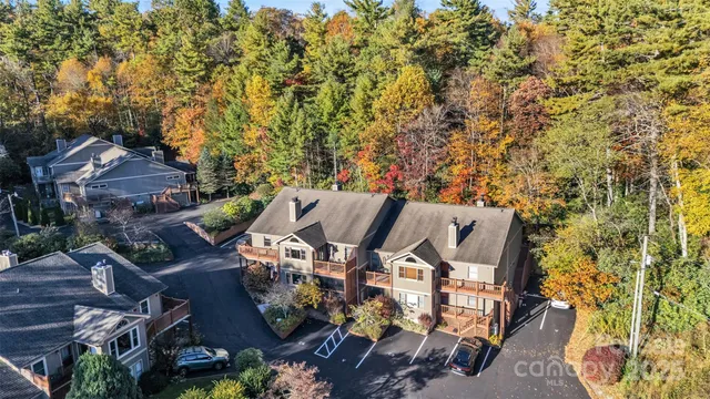 an aerial view of a house with yard and outdoor seating