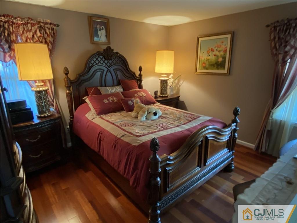 58 Brookside Road Edison, NJ 08817 - Photo 15 of 34 a bed sitting in a bedroom next to a lamp