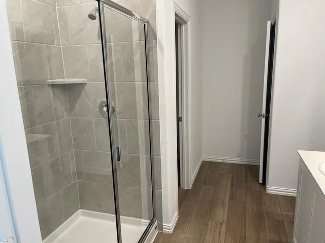 a bathroom with a glass door shower