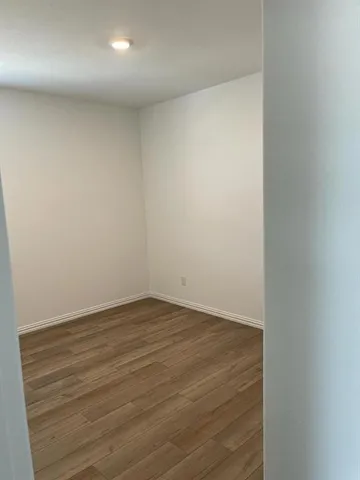 an empty room with wooden floor