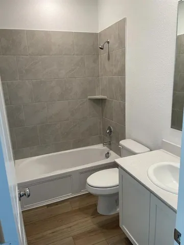 a bathroom with a sink a toilet and a bathtub