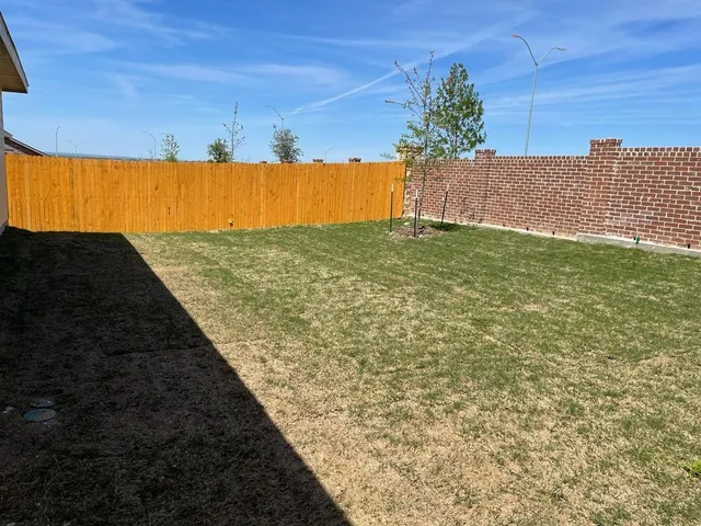 a view of balcony with a yard
