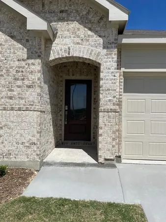 a stone house with a fireplace in front of it