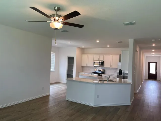 a view of kitchen with living room and wooden floor