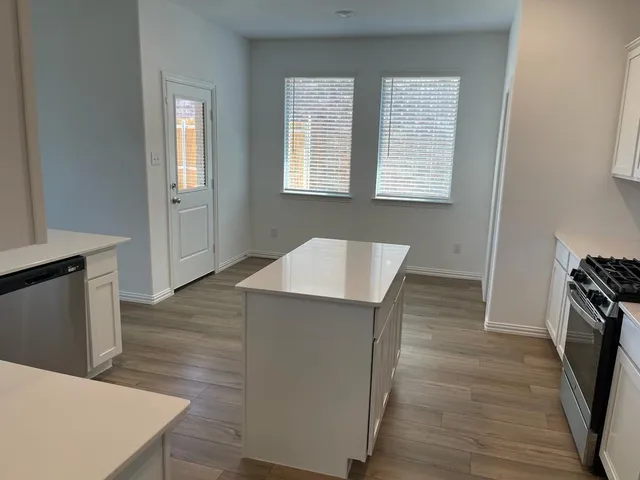 a view of hallway with wooden floor