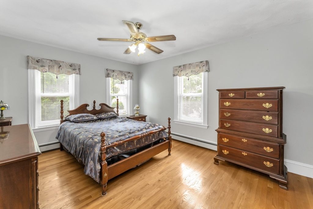 196 Maple Street Boston, MA 02132 - Photo 16 of 33 a bedroom with a bed and a chandelier