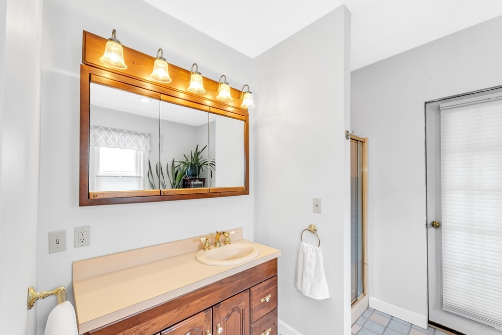 196 Maple Street Boston, MA 02132 - Photo 19 of 33 a bathroom with a sink and a mirror