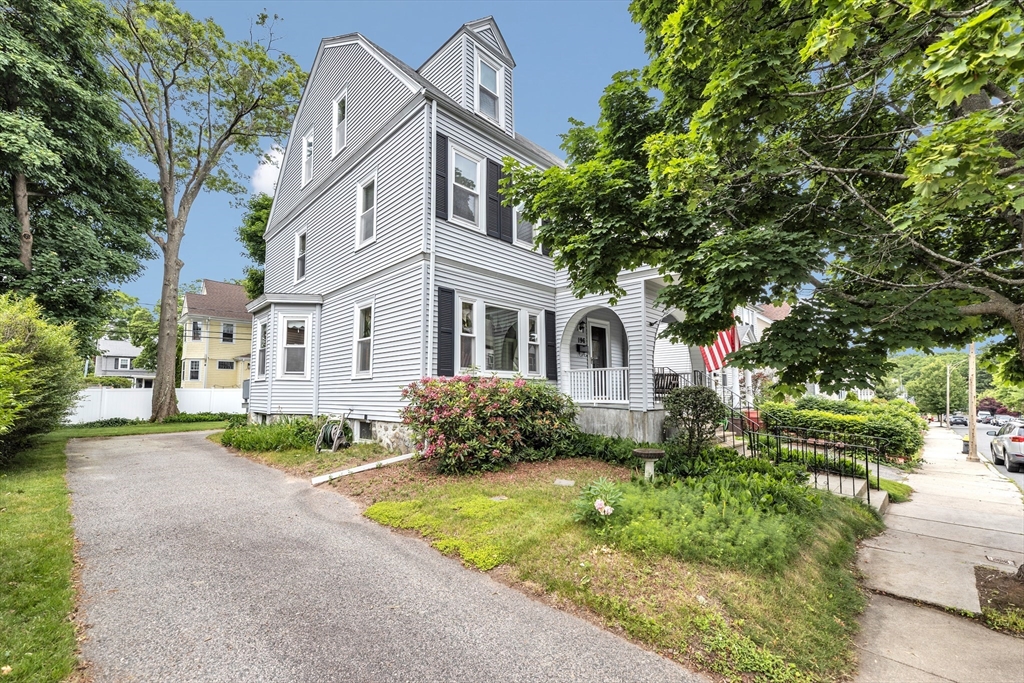 196 Maple Street Boston, MA 02132 - Photo 2 of 33 a front view of a house with a yard and garage