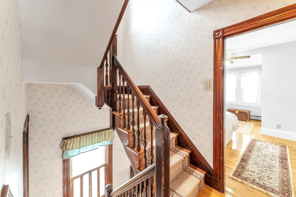 196 Maple Street Boston, MA 02132 - Photo 22 of 33 a view of staircase with wooden floor and a rug
